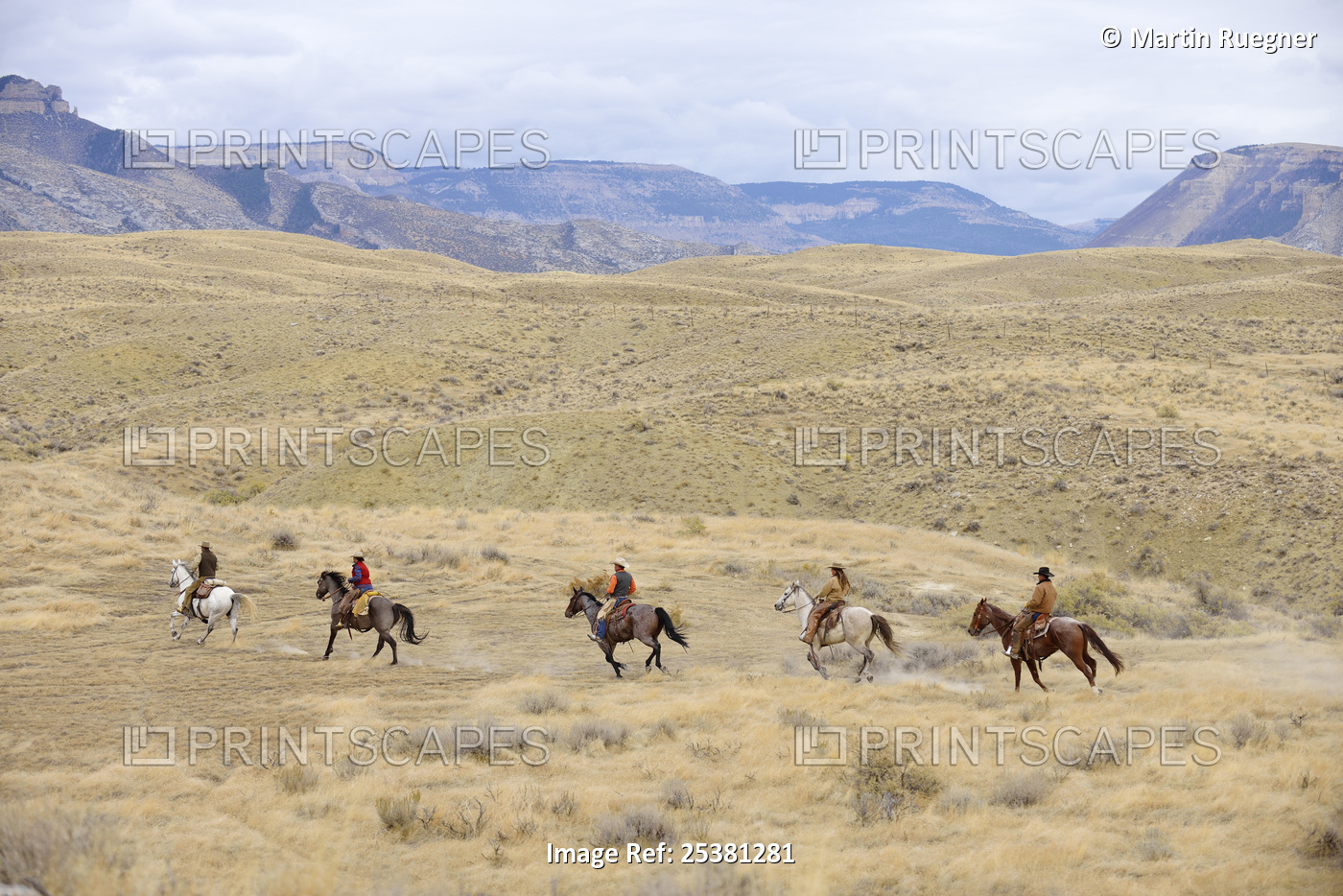 Cowboys and Cowgirls riding horse in wilderness, Rocky Mountains, Wyoming, USA