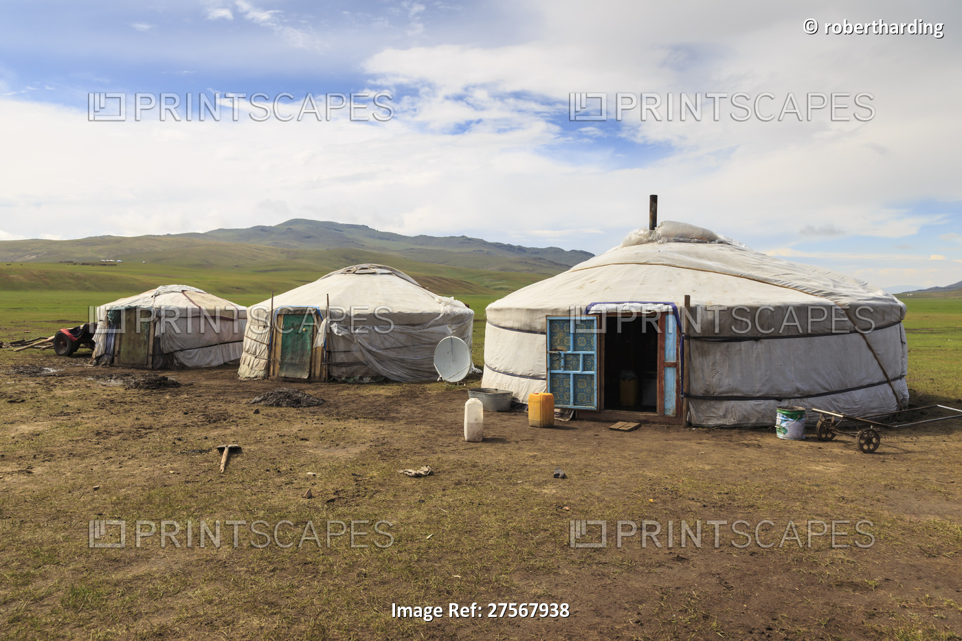 Line of family gers at a Summer nomad camp, distant gers and mountains, ...