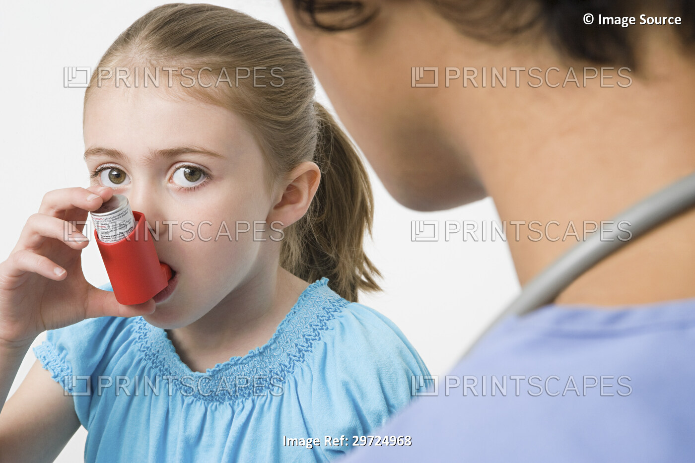 Girl taking asthma inhaler