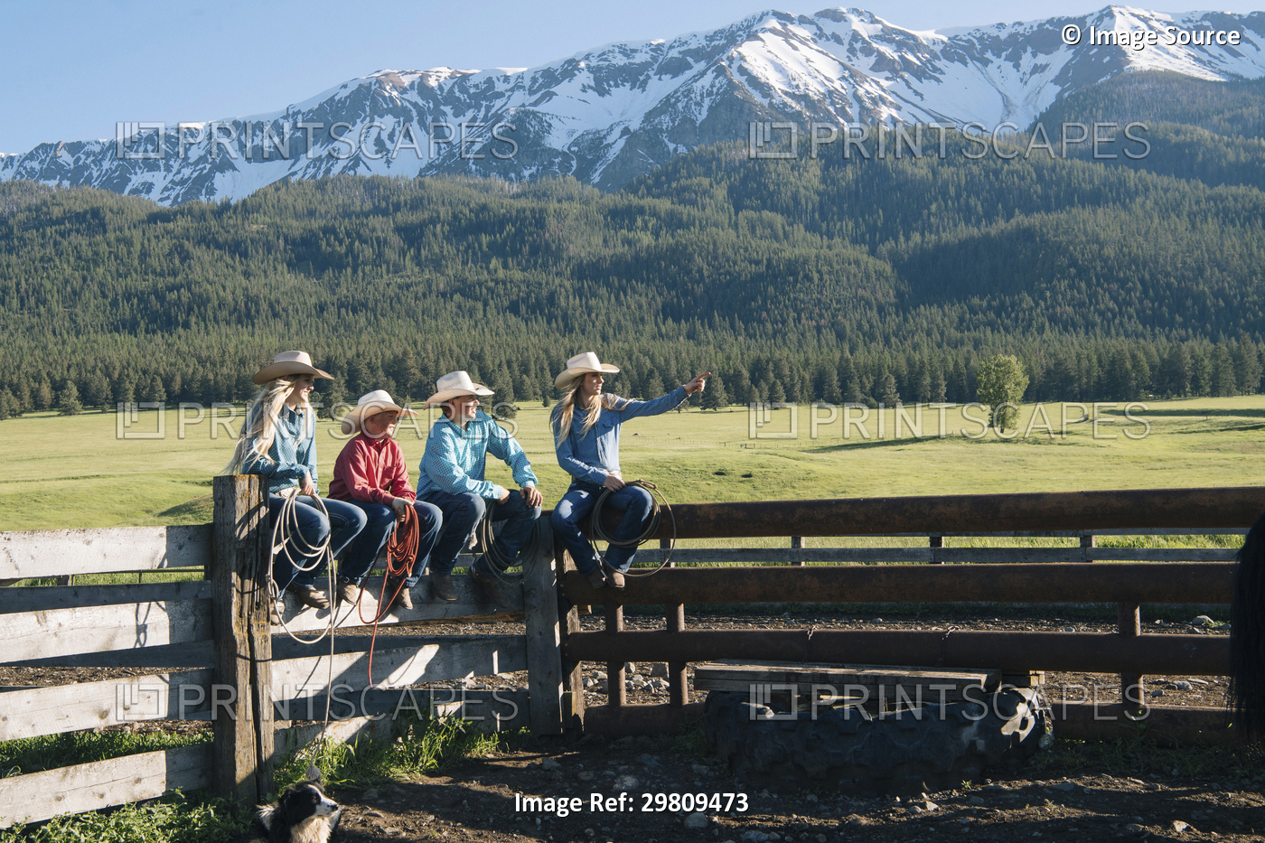 Cowboys and cowgirls on fence, looking away, Enterprise, Oregon, United States, ...