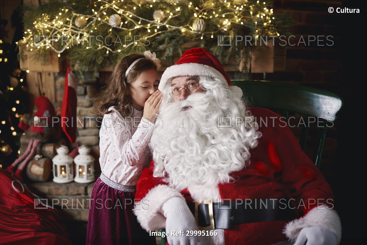 Young girl visiting Santa, whispering into Santa's ear