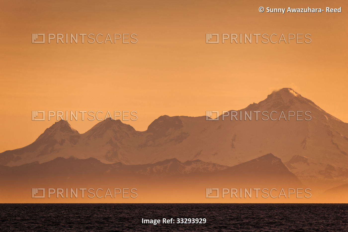 Mount Iliamna in golden orange at sunset, Kenai Peninsula, South-central Alaska ...