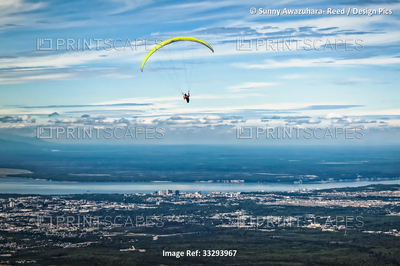 Paragliding over Anchorage under blue sky, Cook Inlet and Downtown Anchorage in ...