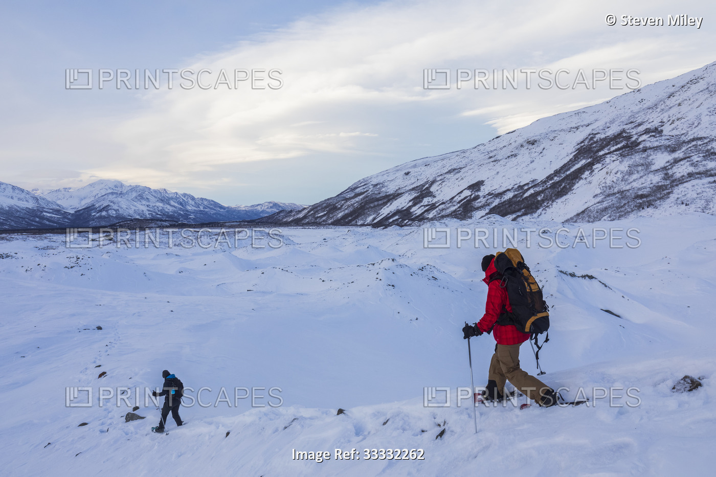 Two women snowshoeing along trail in the Canwell Glacier exploring the Delta ...