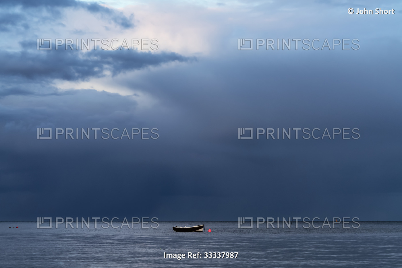 Lone rowboat moored under a dark, stormy sky; Sunderland, Tyne and Wear, England