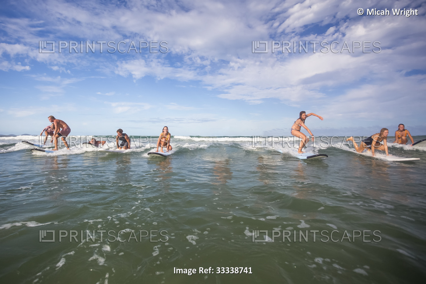 Surfers play around and have a good time with friends while out in the water ...