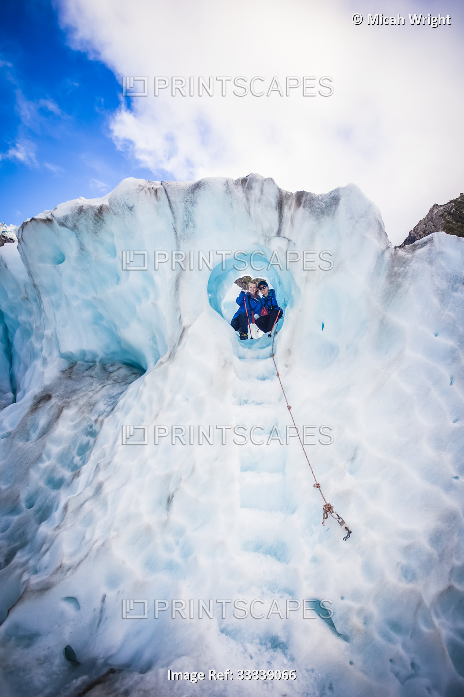 Travellers explore New Zealand's famous Franz Josef Glacier. Blue Ice, deep ...