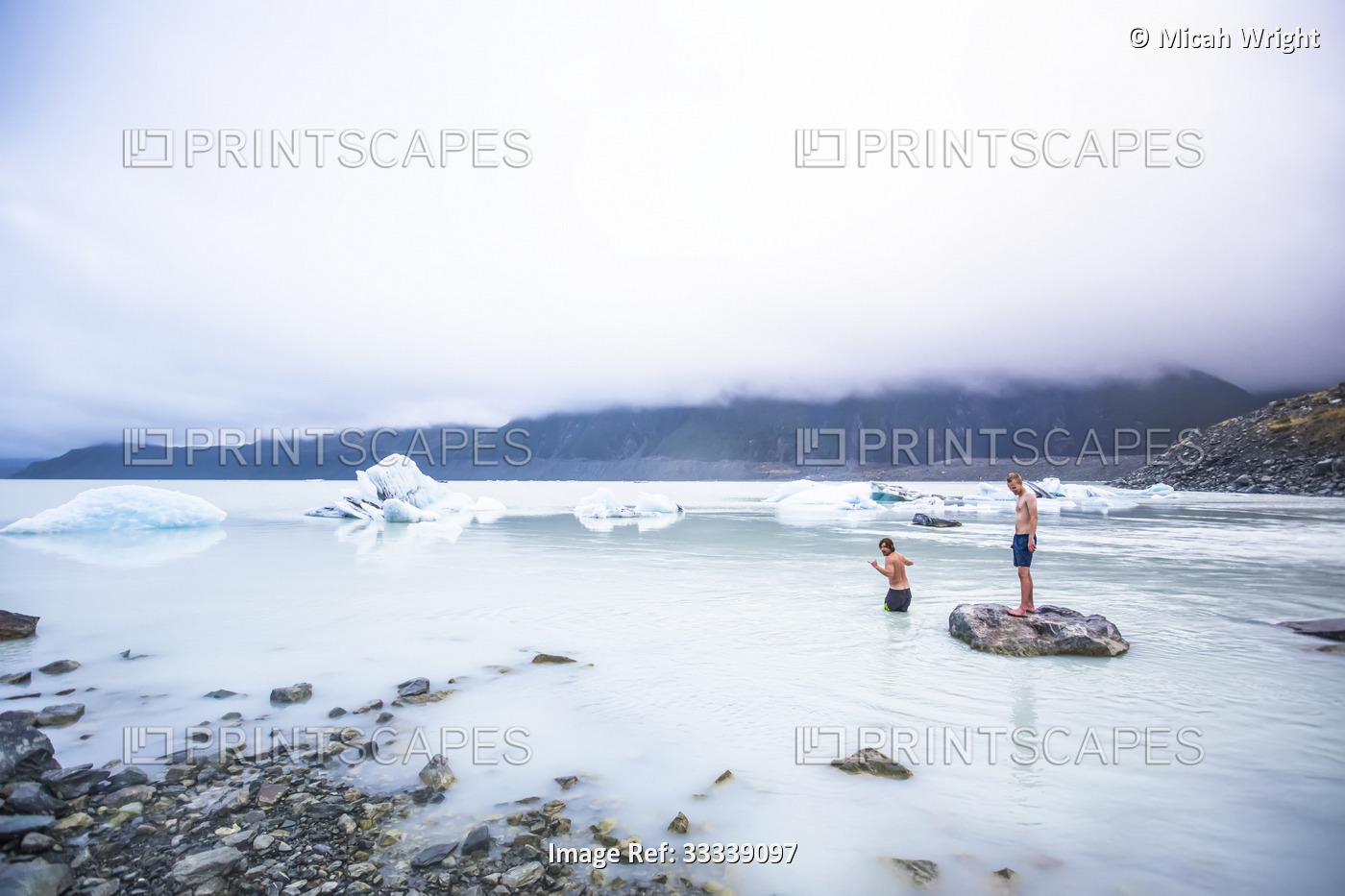 Men swimming in the icy glacial lakes of Mount Cook National Park; Canterbury, ...