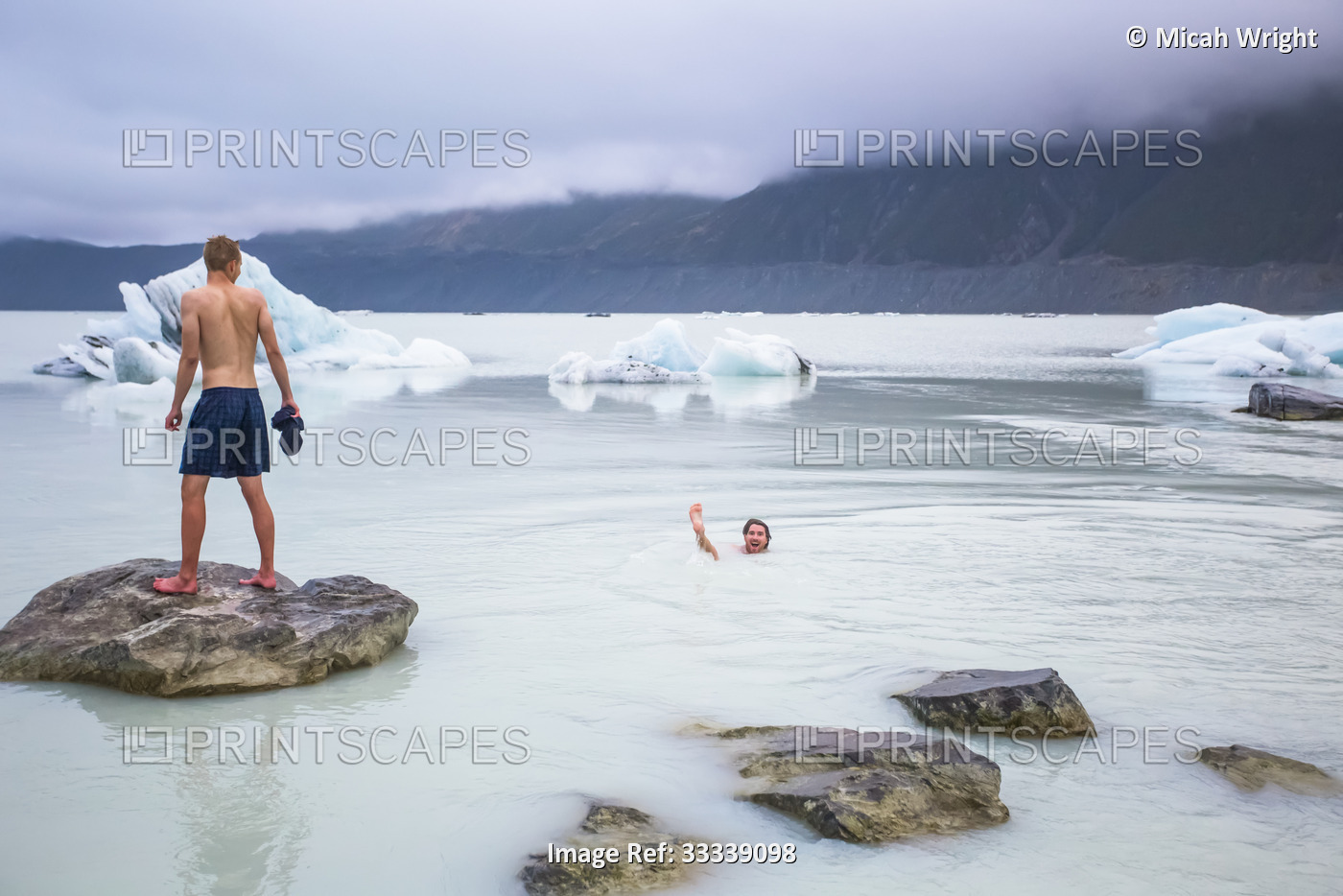 Men swimming in the icy glacial lakes of Mount Cook National Park; Canterbury, ...