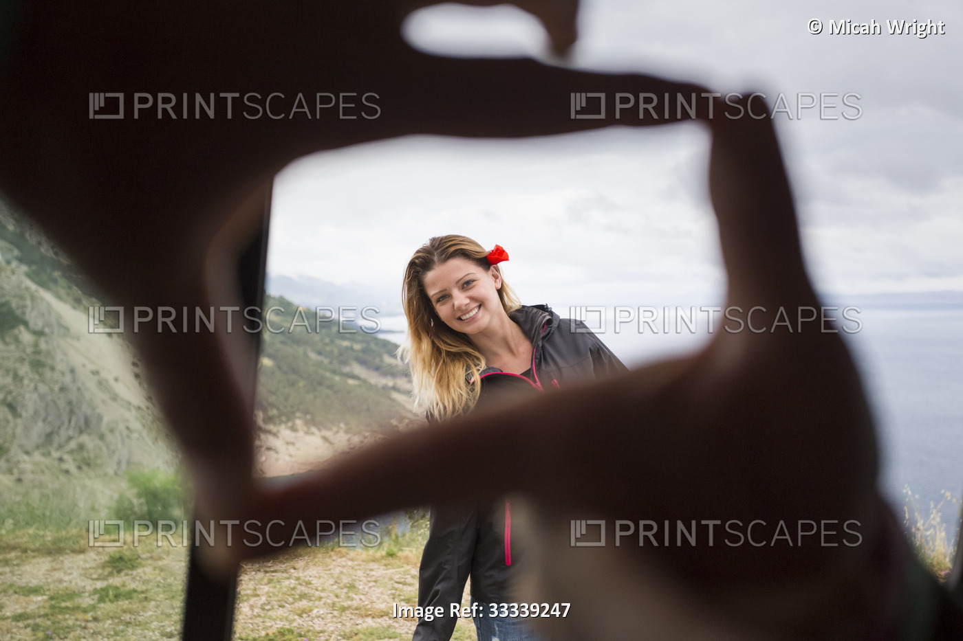 Framing a beautiful girl with fingertips with the Croatian coastline in the ...