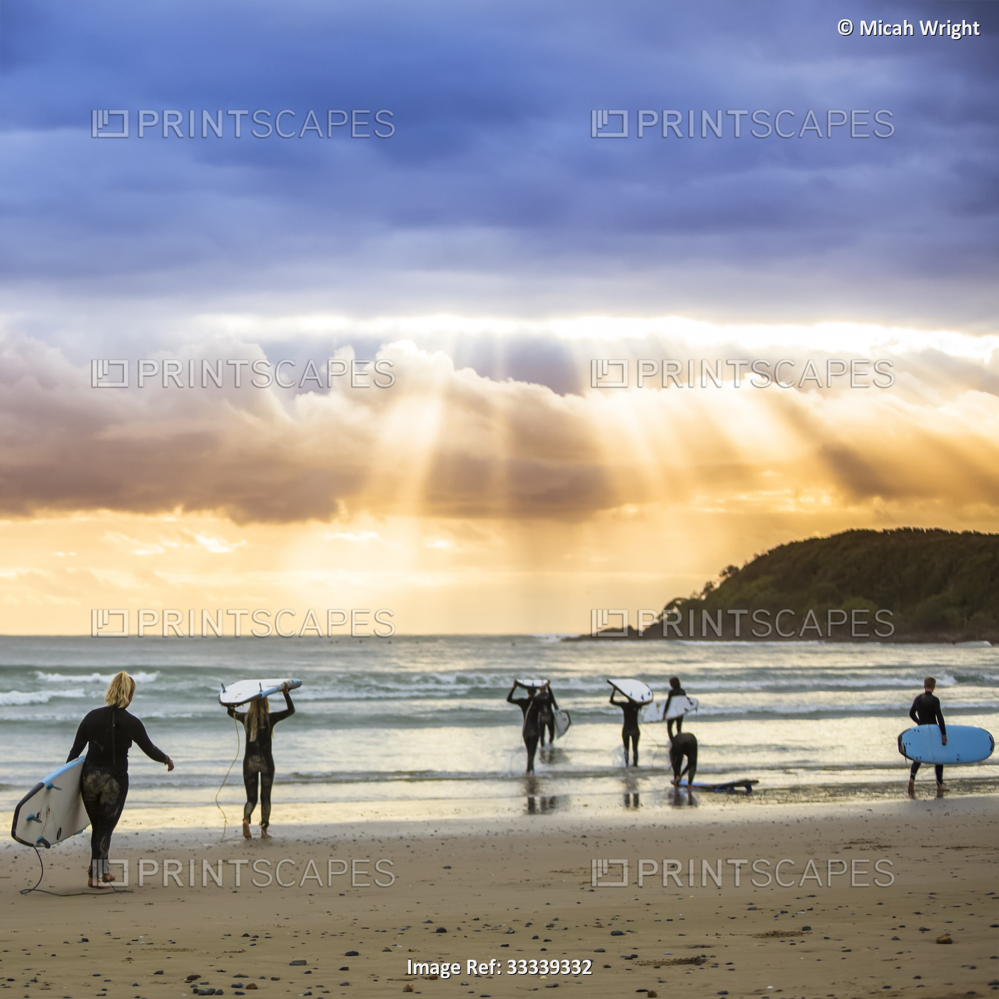 A beautiful sunrise greets surfers as they prepare and paddle out for an early ...