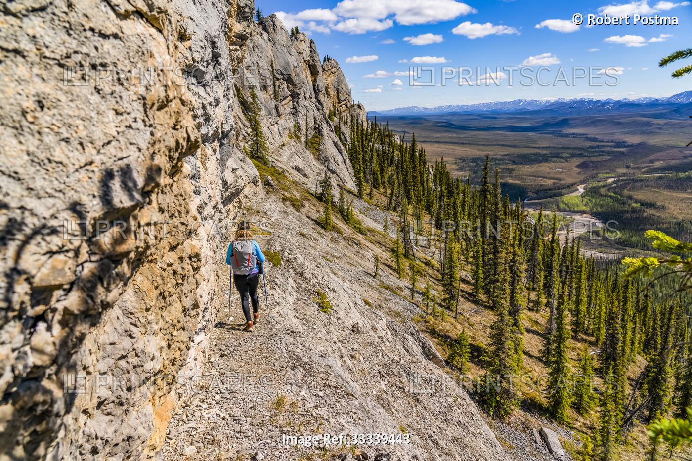 Woman hiking along the Dempster Highway enjoying the scenery on top of Sapper ...