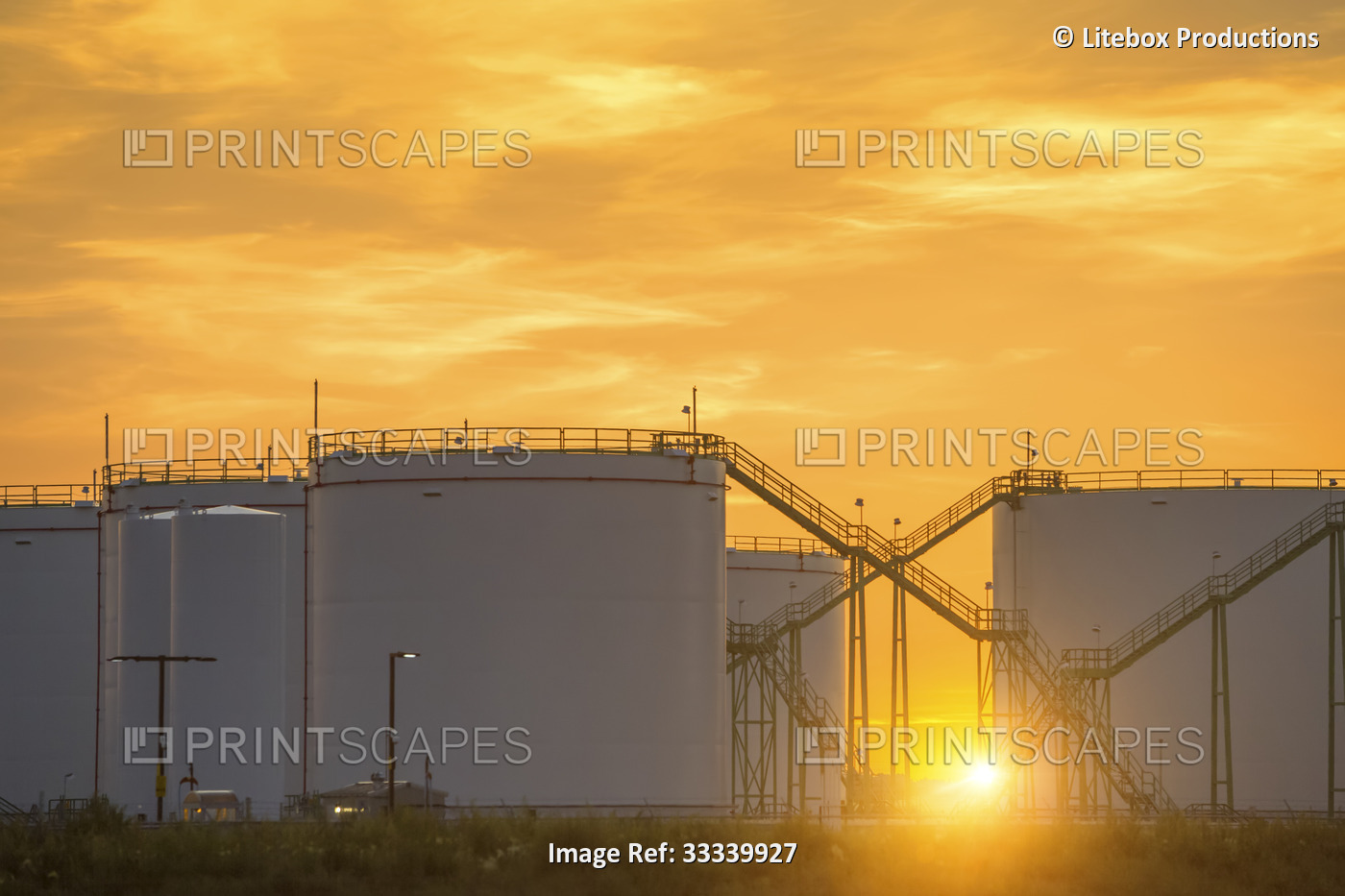 Fuel storage tanks at sunset; Alberta, Canada