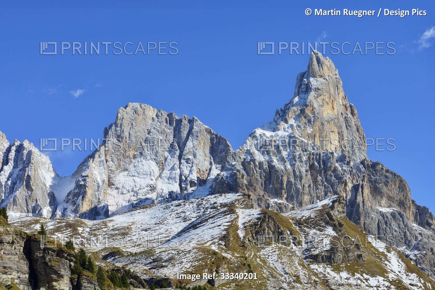 Rugged peaks of the Dolomites against a blue sky; Trentino-Alto Adige, Italy