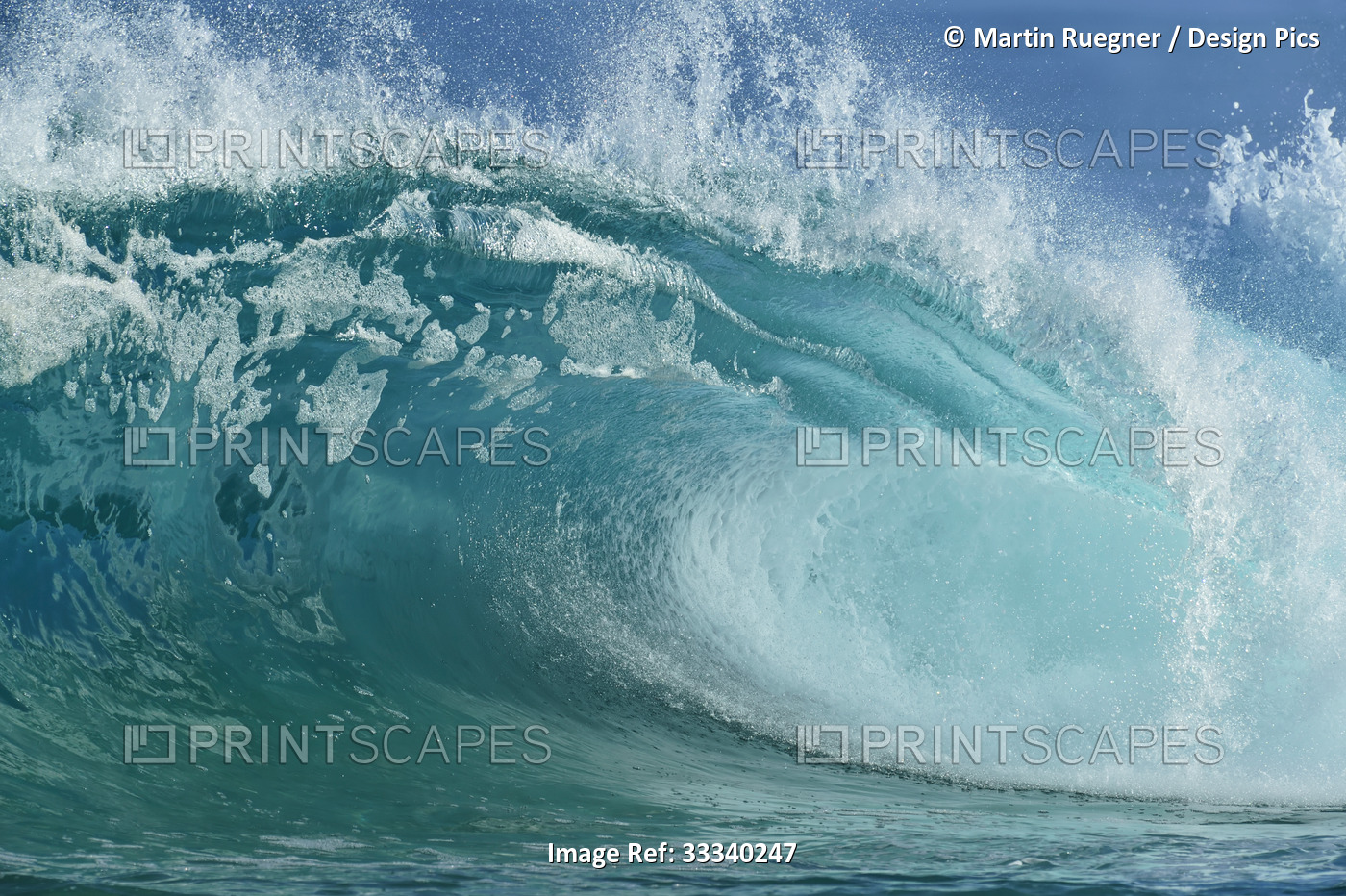 Close-up of turquoise ocean wave breaking with frothy spray; Oahu, Hawaii, ...
