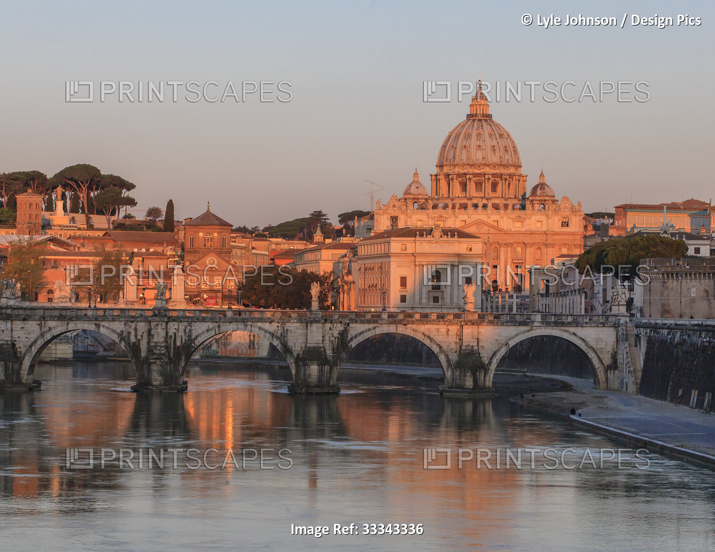 Ponte Sant'Angelo and St. Peters Basilica at sunrise; Rome, Italy