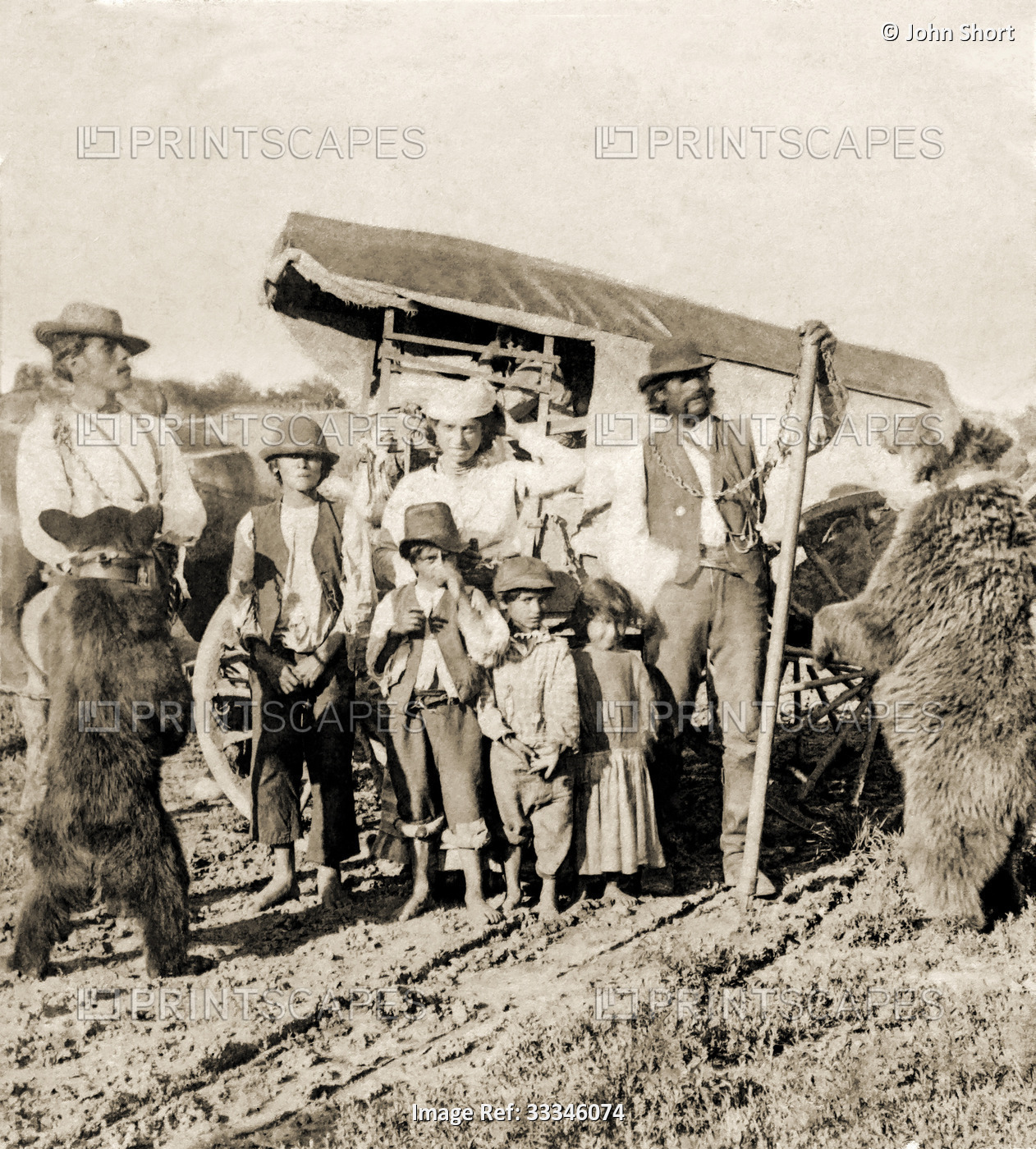 Historic image in sepia tone of a caravan of travelling Gypsies with bears