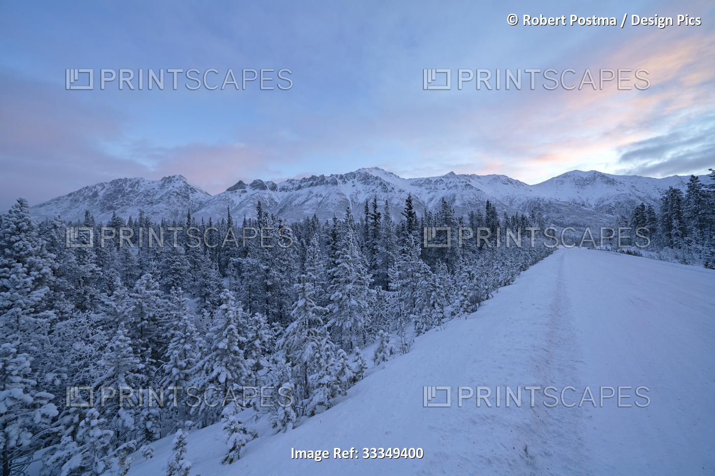 The Alaska Highway stretching into the distance with the morning light rising ...