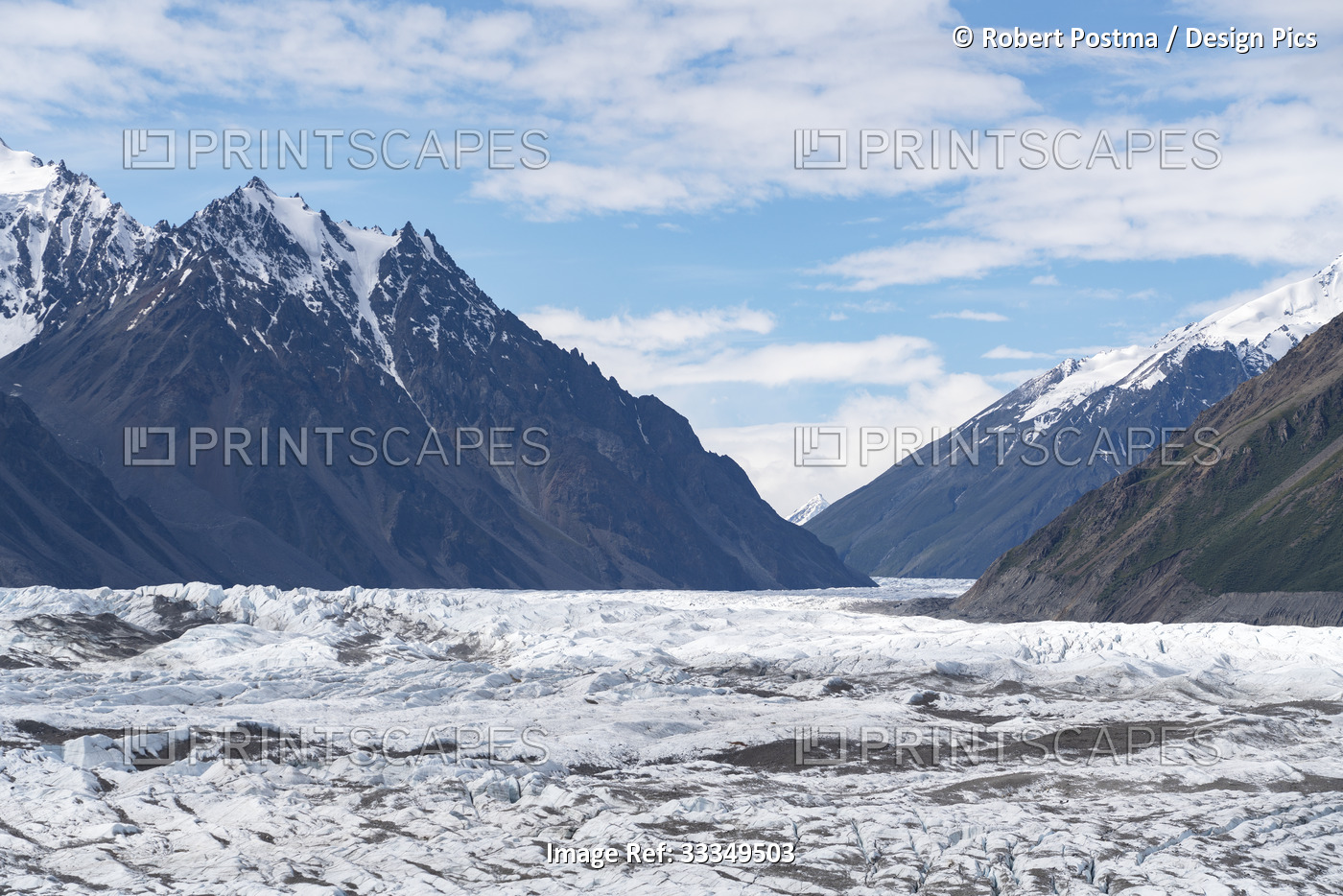 Massive glacial flow ice of the Donjek Glacier through the snowcapped mountain ...