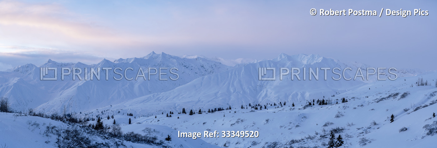 Impressive snow covered mountain ridge along the Haines Highway in the soft, ...