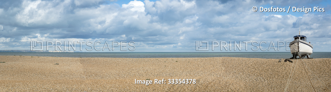 Wooden cabin boat tethered on the shingle beach at Dungeness along the Atlantic ...