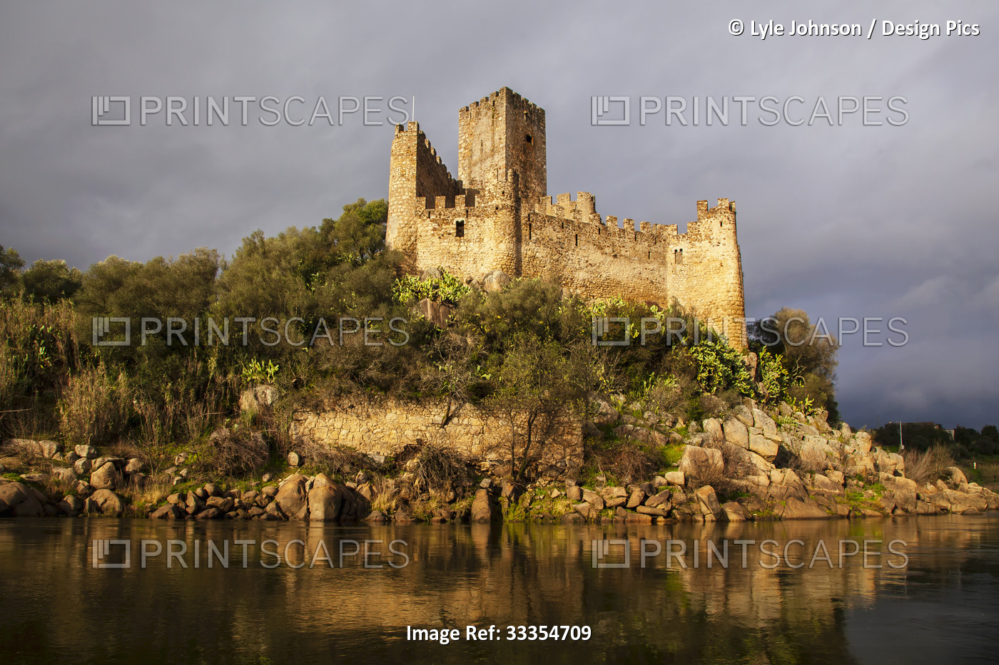 Warm sunlight reflecting on the historical Castlo de Almourol on the islet of ...