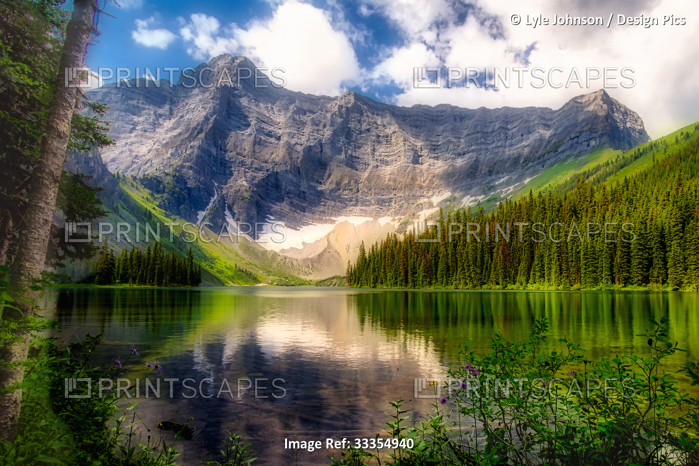 Rawson Lake with a mirror image of forest and mountains in the water, ...