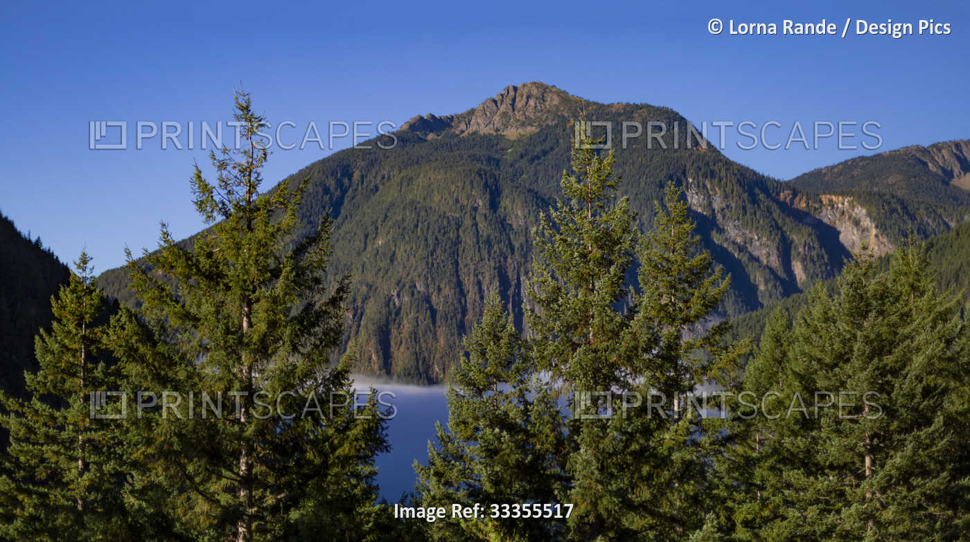 View along the Hope-Princeton Highway, with a lake, mountains and evergreen ...
