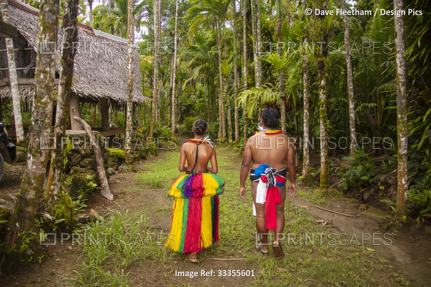 This couple is in a traditional outfit walking down a path through their ...