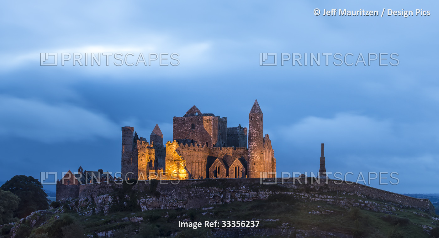 The ancient Rock of Cashel illuminated at dusk; Cashel, County Tipperary, ...