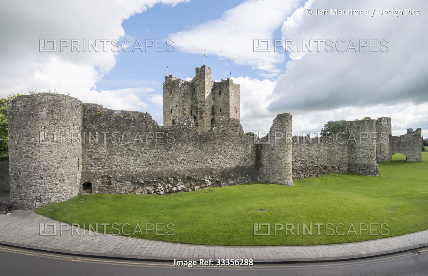 The Norman ruins of Trim Castle and grounds under a cloudy, blue sky; Trim, ...