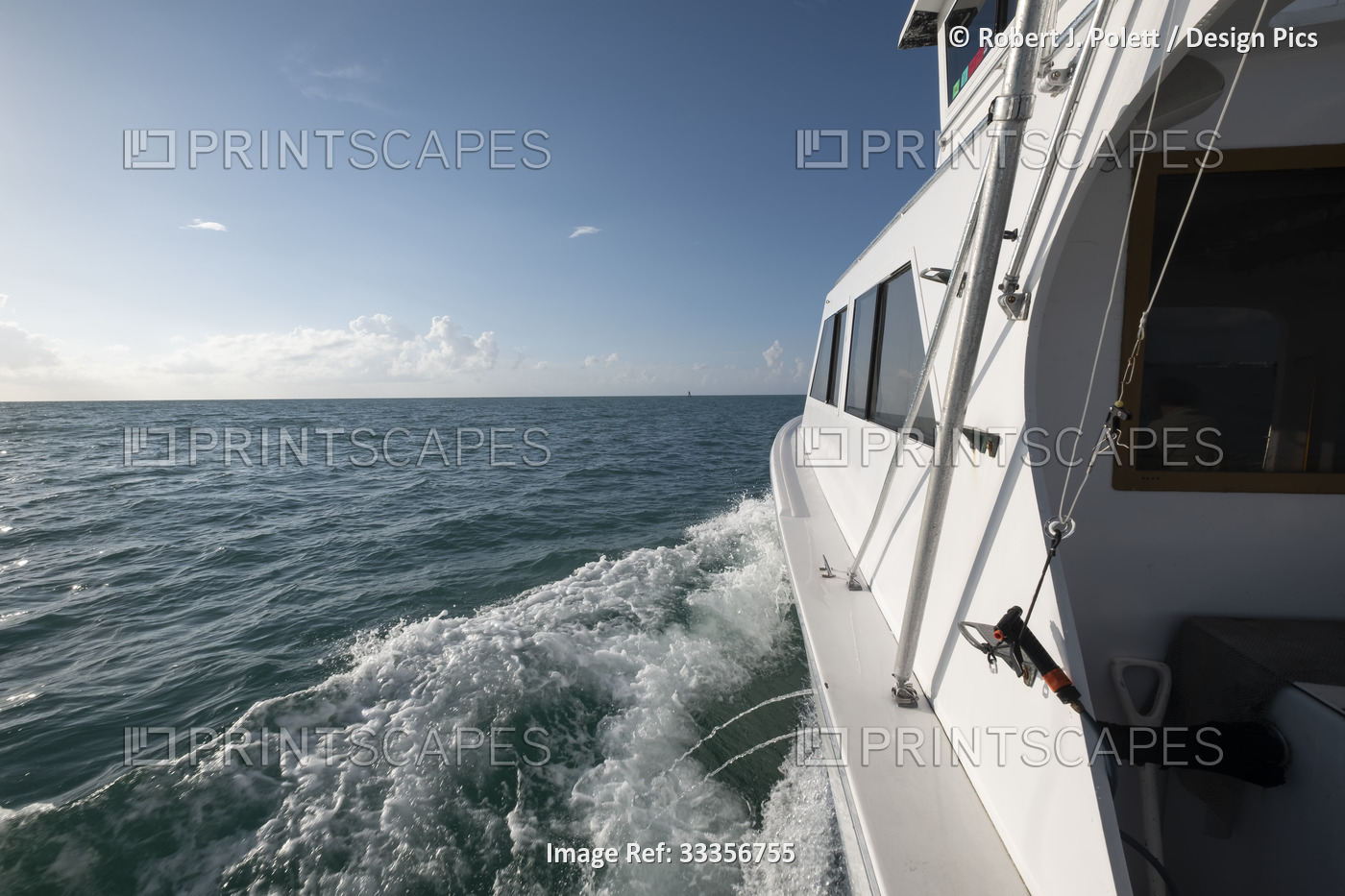 Close-up of the the port side of an offshore sports fishing boat headed out to ...