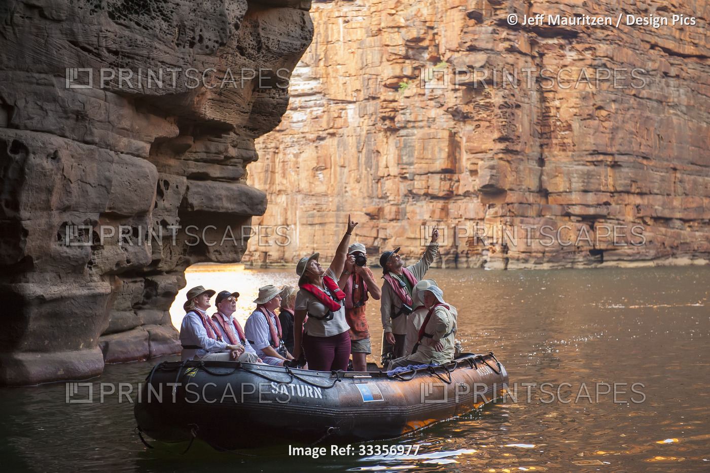 Expedition travellers aboard inflatable boats explore King George River in the ...
