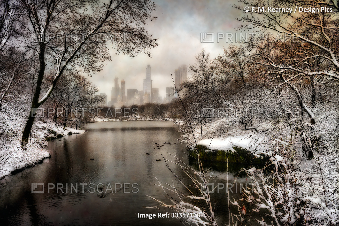 View of the city through the snow covered trees and shoreline around The Lake ...