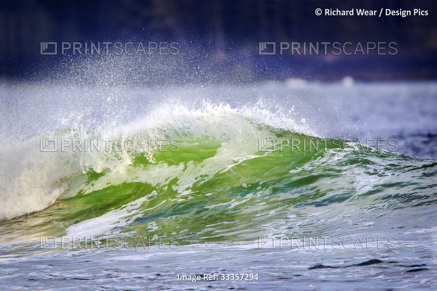 Close-up of ocean spray and a wave with green water, off the coast of Tofino, ...