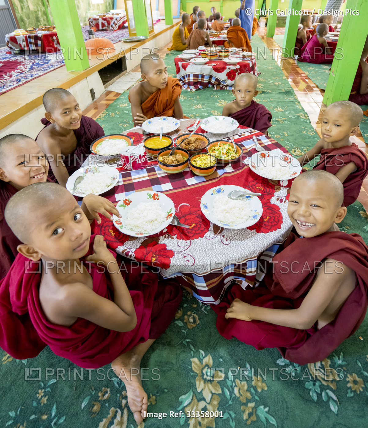 Young boys monks having lunch in a Buddhist monastery in a rural village along ...