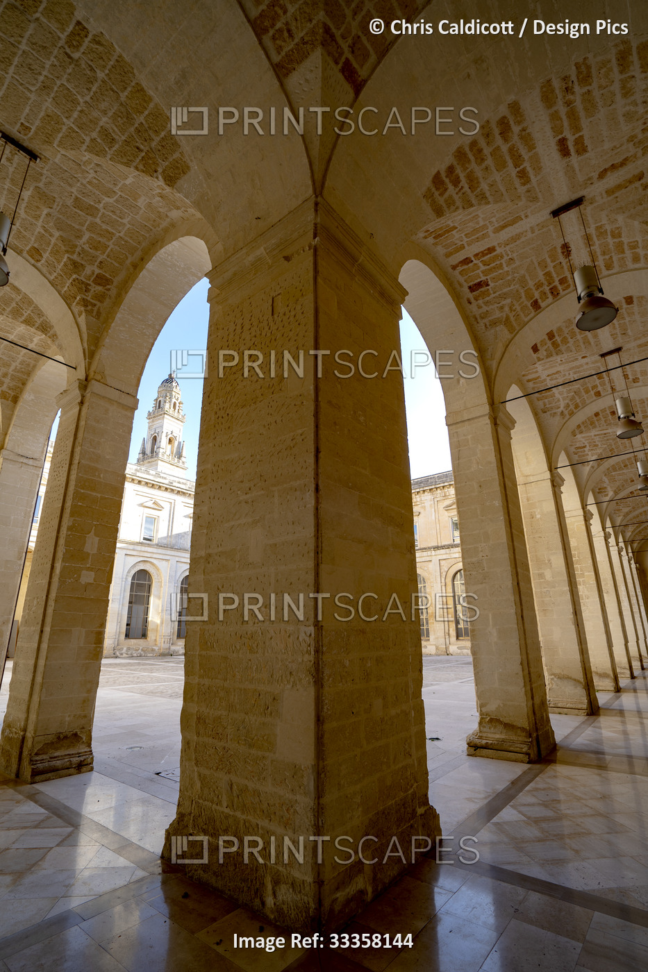 View of the bell tower of the Lecce Cathedral through columns under the portico ...