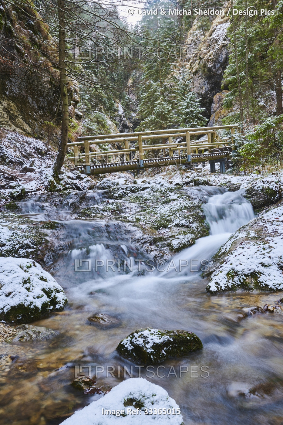 Bridge over a snowy flowing river at Janosikove Diery in winter; Little Fatra ...