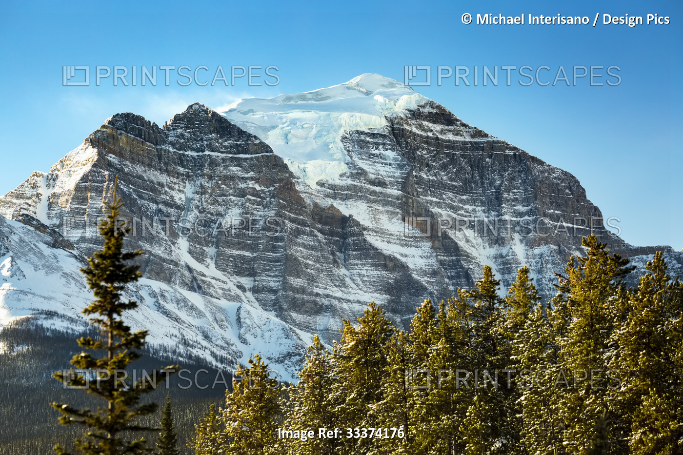 Snow covered Mount Temple with glacier on mountain peak and blue sky, Banff ...