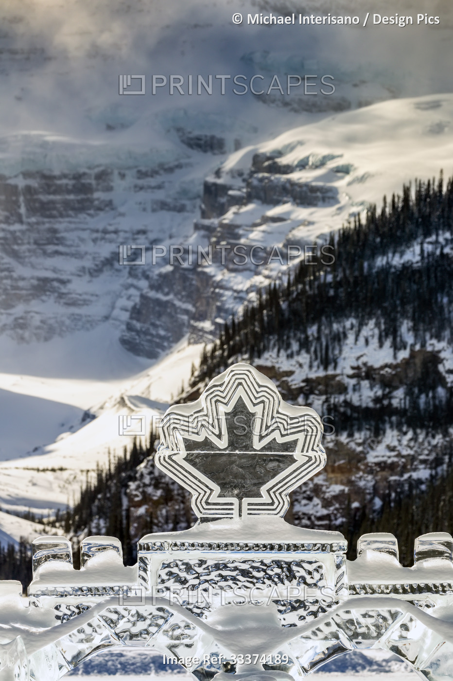 Canadian Maple Leaf Ice Sculpture with a background of a snow covered mountain ...