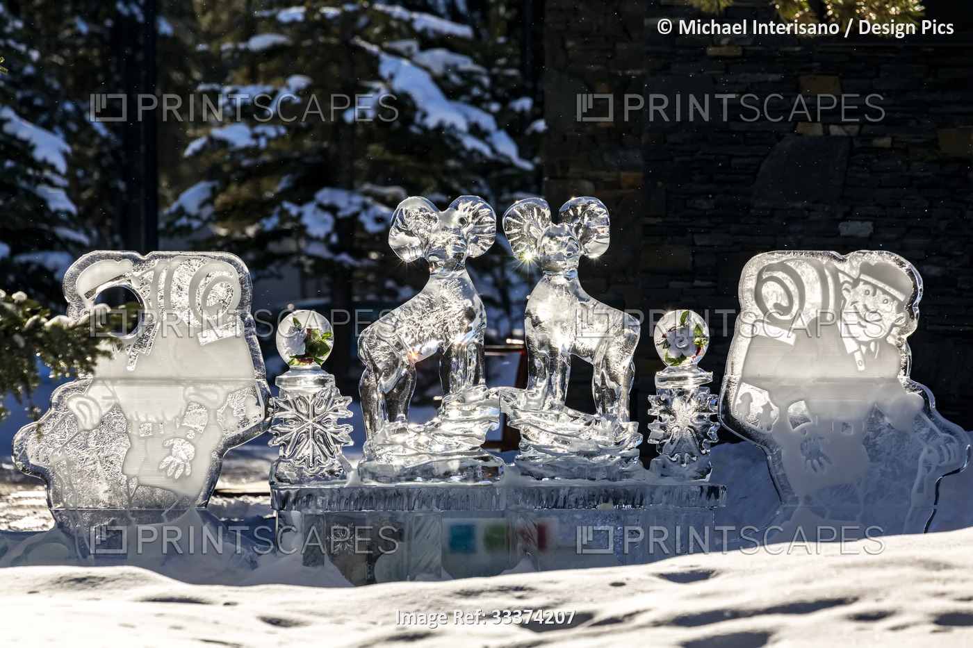 Glowing ice sculptures of mountain sheep and hikers backlit by the sun in Banff ...