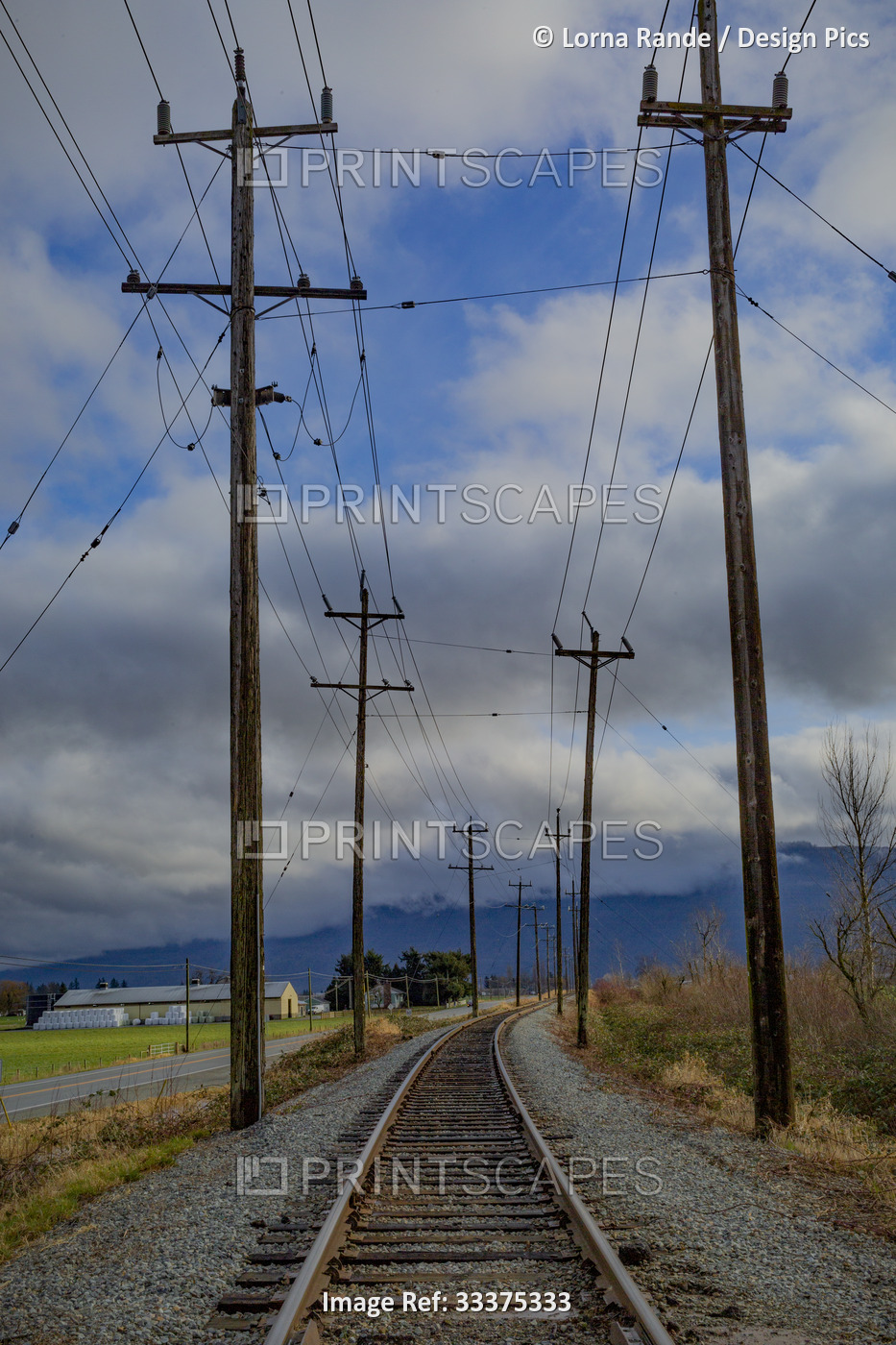 Railroad tracks running through farmland; Abbotsford, British Columbia, Canada