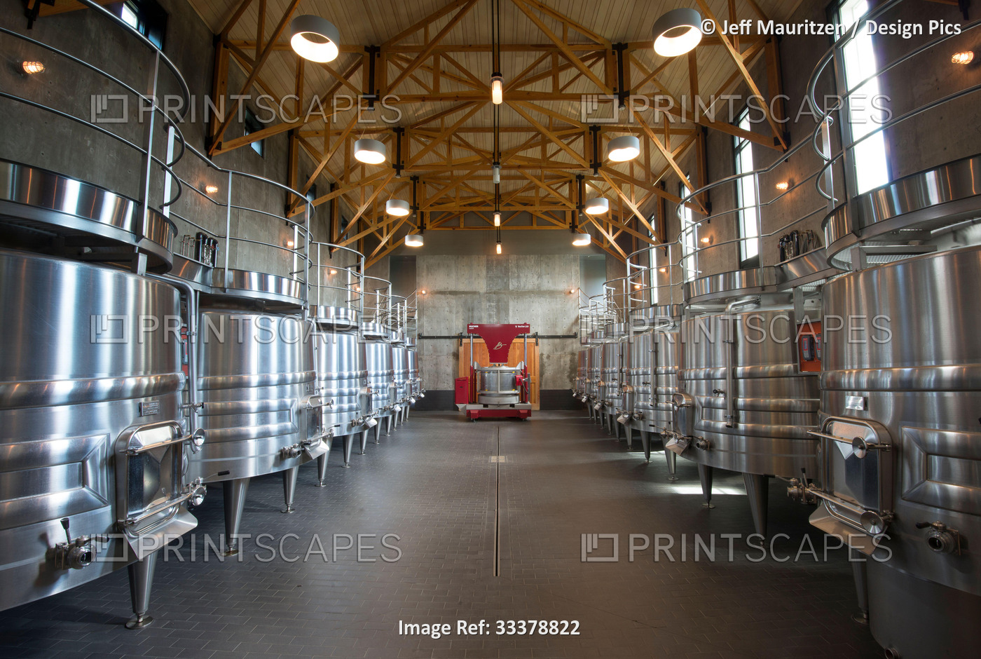 A row of wine fermenters used in wine production inside a winery; Virginia, ...