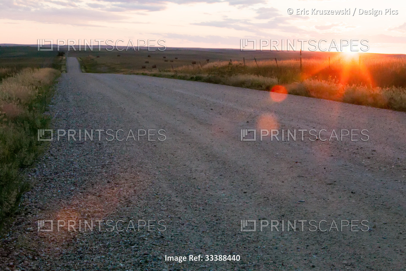The sun sets on the horizon near a long, open country road.; Kadoka, South ...