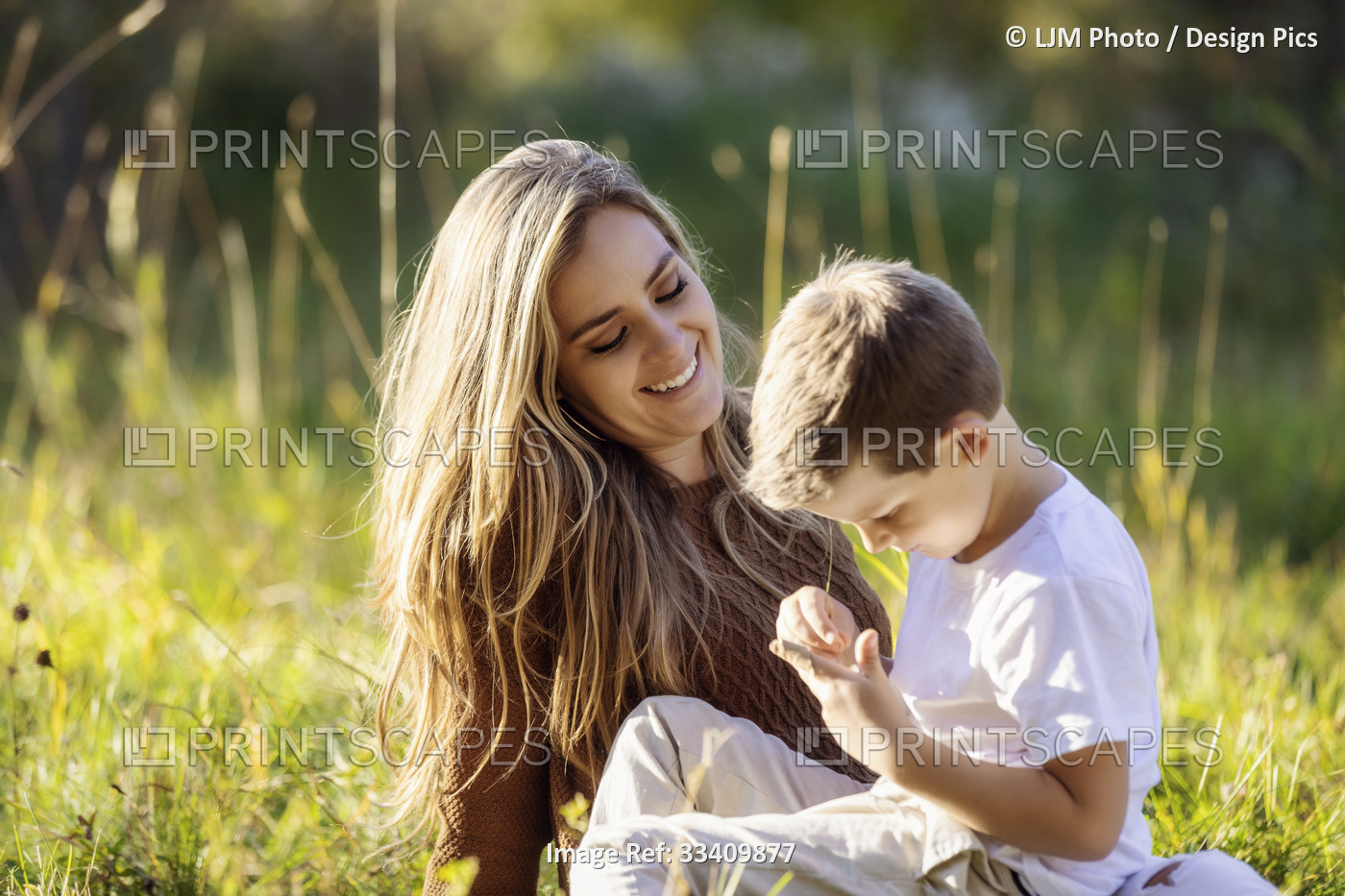 A mother spending quality time with her young son, outdoors in a city park; ...