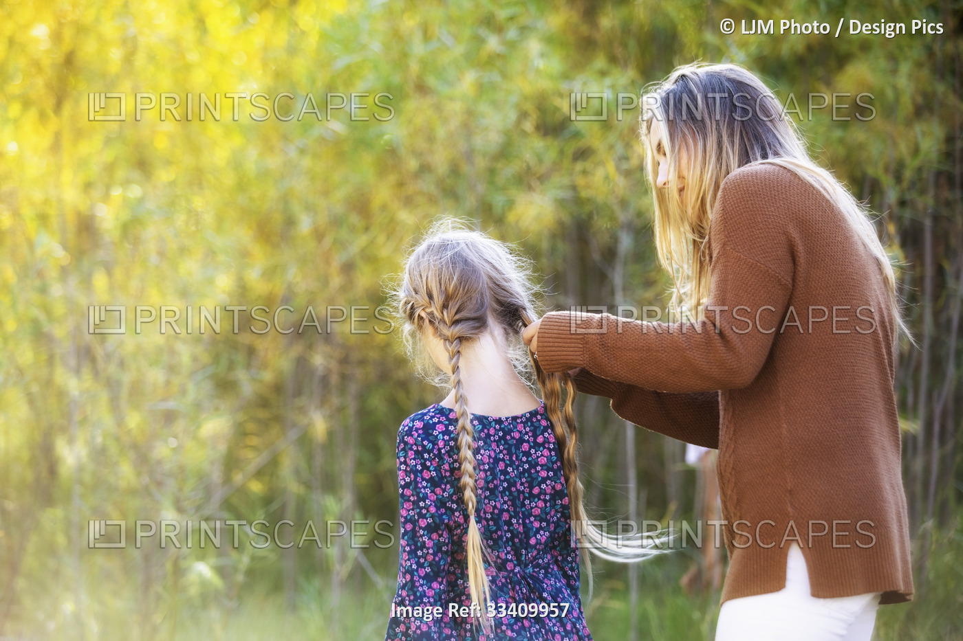 A mother and daughter spending quality time together outdoors and mom is ...