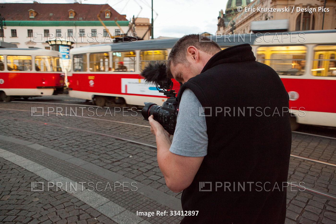 A videographer films in Prague's Republic Square.; Prague, Czech Republic