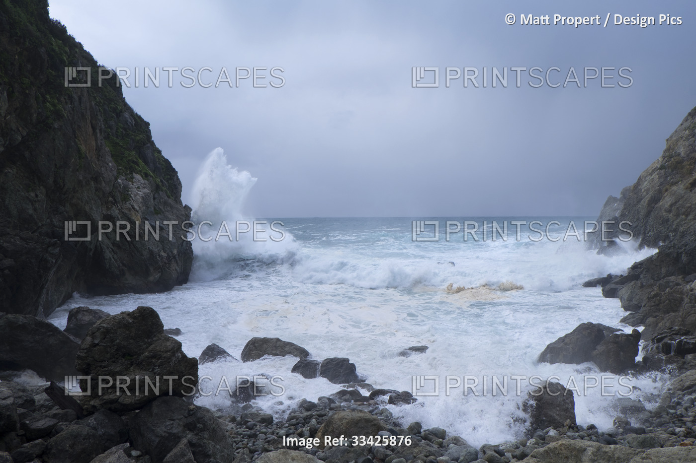 Large storm surf with waves crashing against the rocky shoreline on the coast ...