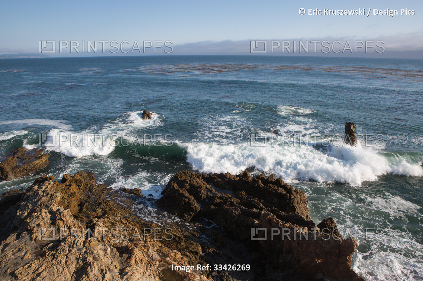 Waves crash onto rock formations on a Pacific coast.; San Simeon Cove, San ...