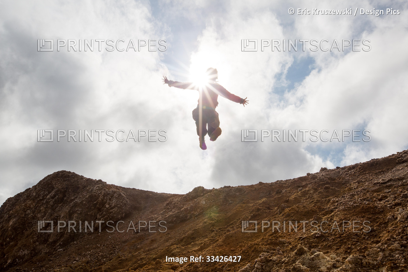 A woman jumps from a hill at the mud pots geothermal area of Lake Myvatn.; ...